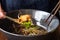 Hand of people using spoon holding thai style beef stewed soup in bowl