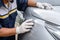 Hand of people using stainless steel wool to polishing the surface of car body