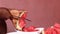 Hand of a person slicing water melon fruit with a knife