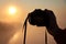 Hand of a photographer with a camera over a river during a sunrise