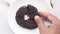 hand pick chocolate cookies on plate