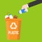 Hand pick plastic bottle waste and colorful recycle bin flat design vector