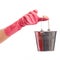 Hand in a pink glove holding silver pail