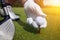 Hand placing a tee with golf ball