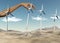 Hand placing wind turbines in a desert