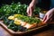 hand plating a fillet of baked salmon with greens