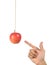 Hand point the hanging apple.