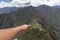 hand pointing to machu picchu, Huaynapicchu Mountain, Machu Picchu, Peru - Ruins of Inca Empire city