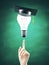 Hand points to lightbulb with graduation hat