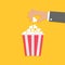 Hand and popcorn. Flat style icon.