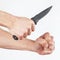 Hand position to attack with a army knife on white background