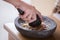 Hand pounding herbs on a traditional pounder