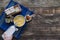 Hand pouring milk into a doughnut cup on a rustic wooden base. Latin food concept. Copy space