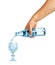 Hand pouring mineral water from galss bottle