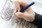 hand practices decorating letters from a Torah scroll written on parchment in Hebrew