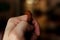 Hand of prayer holding rudraksha beads or rosary.