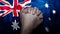 A hand praying with Flag of Australia as background. Grunge, depressing look.