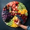 Hand preparing round fruit platter