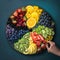 Hand preparing round fruit platter