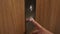 Hand presses elevator button to go down extreme close view