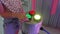 The hand presses the multi-colored glowing buttons of the light bulb.