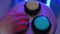 The hand presses the multi-colored glowing buttons of the light bulb.
