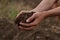 Hand of professional farmer hold soil from ground