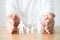 Hand protecting family on wood table