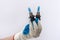 Hand in protective glove holding led halogen headlight bulb,isolated. car lighting technology  for repair