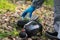 Hand in a protective suit and a rubber glove takes a mask to protect respiratory organs from the ground