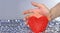 Hand protects the heart. Heart shape. Blurred background