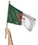 Hand proudly waving the national flag of Algeria
