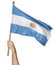 Hand proudly waving the national flag of Argentina