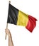 Hand proudly waving the national flag of Belgium