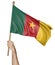 Hand proudly waving the national flag of Cameroon