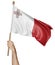 Hand proudly waving the national flag of Malta