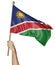 Hand proudly waving the national flag of Namibia