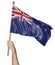 Hand proudly waving the national flag of New Zealand