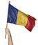 Hand proudly waving the national flag of Romania