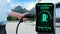 Hand pull EV charger from smart electric charging station. Peruse