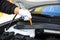 Hand pulling a car`s dipstick. Checking engine oil step by step