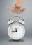 Hand puppeteer manipulating clock, time management concept