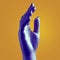 Hand of purple mannequin on orange background