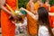 Hand while put food offerings in a Buddhist monk\'s alms bowl. f