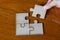 Hand put the last piece of jigsaw puzzle to complete the mission, Business solutions, success and strategy concept