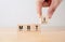 Hand puts wooden cubes with MBTI, Myers-Briggs Type Indicator on table