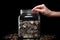 Hand putting coins into full glass jar put save money future investment saving cost financial plans currency inflation