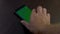 Hand putting down cellphone with chroma green screen