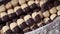 Hand putting homemade Christmas cookies into a box, closeup