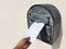 Hand putting a letter in the mailbox with copy space on the left side.